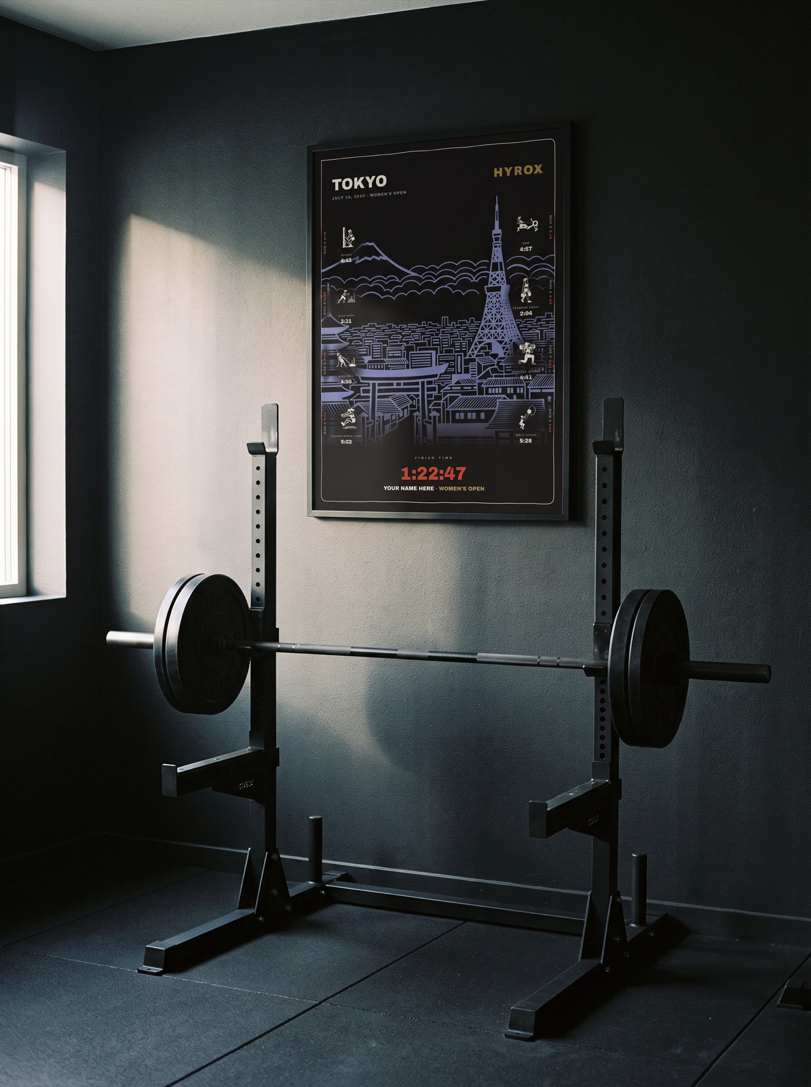The Noir Tokyo women's edition in a black frame behind a squat rack