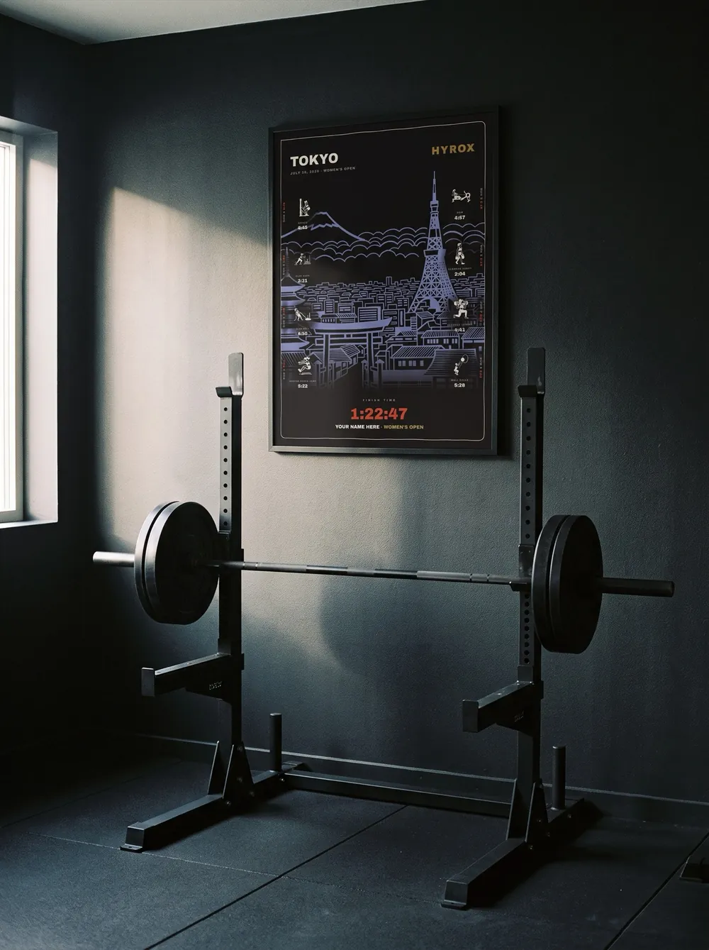 The Noir Tokyo women's edition in a black frame behind a squat rack